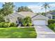 Charming single-story home with lush landscaping and a well-manicured lawn at 10306 Palmbrooke Ter, Bradenton, FL 34202