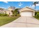 Beautifully landscaped single-story home with a spacious driveway leading to a two-car garage at 10306 Palmbrooke Ter, Bradenton, FL 34202