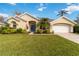 Well-maintained one-story home with vibrant landscaping and a bright blue front door at 10306 Palmbrooke Ter, Bradenton, FL 34202
