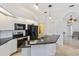 Modern kitchen with white cabinets, granite countertops, and stainless steel appliances at 10306 Palmbrooke Ter, Bradenton, FL 34202