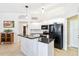 Bright kitchen with white cabinetry, black appliances and granite countertops at 10306 Palmbrooke Ter, Bradenton, FL 34202
