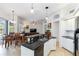 Open floor plan showcasing a kitchen with black granite counters and adjacent living area at 10306 Palmbrooke Ter, Bradenton, FL 34202