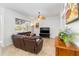 Bright living room with tile floors, ceiling fan, and a large window overlooking the backyard at 10306 Palmbrooke Ter, Bradenton, FL 34202