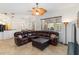 Spacious living room with tile floors, ceiling fan, and large sectional sofa at 10306 Palmbrooke Ter, Bradenton, FL 34202