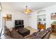 Open-concept living room with brown leather seating, tile floors, and an open layout at 10306 Palmbrooke Ter, Bradenton, FL 34202