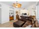Bright living room showcasing a brown leather sectional sofa, neutral decor and arched doorways at 10306 Palmbrooke Ter, Bradenton, FL 34202