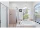 Inviting main bathroom with a large soaking tub and separate walk-in shower at 10306 Palmbrooke Ter, Bradenton, FL 34202