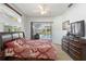 The main bedroom features a sliding glass door leading to a screened lanai and pool at 10306 Palmbrooke Ter, Bradenton, FL 34202