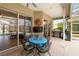Enclosed patio with an outdoor kitchen and dining set, ideal for entertaining guests at 10306 Palmbrooke Ter, Bradenton, FL 34202