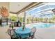 Enclosed patio with a pool, outdoor kitchen, and dining set, creating the perfect backyard oasis at 10306 Palmbrooke Ter, Bradenton, FL 34202