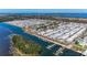 Community aerial view showcasing waterfront homes and a marina with easy access to the open water at 10315 Cortez W Rd # 17F, Bradenton, FL 34210