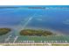 Stunning aerial view of the beautiful waterfront featuring boat docks, lush islands and open water access at 10315 Cortez W Rd # 17F, Bradenton, FL 34210