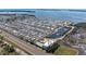 Expansive aerial view showcasing the community's layout, water features, and proximity to the bay at 10315 Cortez W Rd # 17F, Bradenton, FL 34210