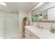 Bathroom featuring a glass door shower, a white vanity, and a decorative, patterned tile floor at 10315 Cortez W Rd # 17F, Bradenton, FL 34210