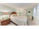 Bedroom featuring calming green walls, a queen bed, and bright, natural light at 10315 Cortez W Rd # 17F, Bradenton, FL 34210