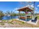 Beautiful gazebo featuring two swings and serene water views, surrounded by lush greenery at 10315 Cortez W Rd # 17F, Bradenton, FL 34210