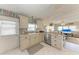 Inviting kitchen with white cabinets, neutral countertops and adjacent living area at 10315 Cortez W Rd # 17F, Bradenton, FL 34210
