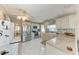 Well-lit kitchen featuring white cabinets, stainless steel appliances, and ample counter space at 10315 Cortez W Rd # 17F, Bradenton, FL 34210