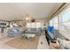 Cozy living room with comfortable sofas, a modern ceiling fan, and bright windows at 10315 Cortez W Rd # 17F, Bradenton, FL 34210