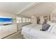 Bright main bedroom features white furnishings, TV, ceiling fan, and an ensuite bathroom at 10315 Cortez W Rd # 17F, Bradenton, FL 34210
