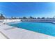Community swimming pool with clear blue water, lounging chairs, and ample space at 10315 Cortez W Rd # 17F, Bradenton, FL 34210