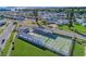 Aerial view of the community tennis courts with green space near homes at 10315 Cortez W Rd # 17F, Bradenton, FL 34210