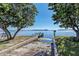 Stunning waterfront view with private boat launch and dock surrounded by mature trees at 10315 Cortez W Rd # 17F, Bradenton, FL 34210