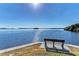 Tranquil waterfront view with a comfortable bench, ideal for enjoying serene sunsets and bay views at 10315 Cortez W Rd # 17F, Bradenton, FL 34210