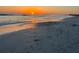 Calm beach scene with gentle waves and beautiful sunset skies at 1141 W Peppertree Dr # 1141, Sarasota, FL 34242