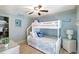 Charming bedroom features a white bunk bed, ceiling fan, and light blue walls at 1141 W Peppertree Dr # 1141, Sarasota, FL 34242