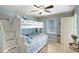 Cozy bedroom with a white bunk bed, window, and light hardwood floors at 1141 W Peppertree Dr # 1141, Sarasota, FL 34242