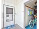 Inviting entryway features a screen door and view into a storage area with a bicycle at 1141 W Peppertree Dr # 1141, Sarasota, FL 34242