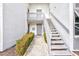 Inviting exterior view with a quaint stairwell, walkway, and nicely manicured landscaping at 1141 W Peppertree Dr # 1141, Sarasota, FL 34242