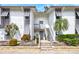 Charming condo exterior with gray shutters, brick accents, and beautiful landscaping for curb appeal at 1141 W Peppertree Dr # 1141, Sarasota, FL 34242