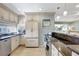Well-lit kitchen features stainless appliances, granite countertops, and tiled flooring at 1141 W Peppertree Dr # 1141, Sarasota, FL 34242