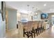 Kitchen bar seating with granite counters and pendant lighting at 1141 W Peppertree Dr # 1141, Sarasota, FL 34242