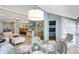 Bright living room with open layout, coastal decor, and dining area with seating for four at 1141 W Peppertree Dr # 1141, Sarasota, FL 34242