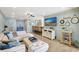 A bright living room with a comfortable sectional sofa and a stylish entertainment center at 1141 W Peppertree Dr # 1141, Sarasota, FL 34242