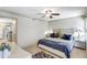 Cozy main bedroom with a soft rug, comfortable lighting, and ceiling fan at 1141 W Peppertree Dr # 1141, Sarasota, FL 34242