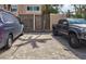 View of a brick-paved parking area with vehicles, surrounded by lush greenery at 1141 W Peppertree Dr # 1141, Sarasota, FL 34242
