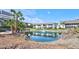 Scenic view of a pond with a fountain, surrounded by beautiful landscaping and condos at 1141 W Peppertree Dr # 1141, Sarasota, FL 34242