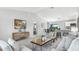 A spacious living room boasts neutral tones, stylish furnishings, and an open floor plan concept at 12042 Crossgate Ave, Port Charlotte, FL 33981