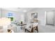 Bright and airy living room featuring a large window with ample natural light and comfortable seating at 12042 Crossgate Ave, Port Charlotte, FL 33981