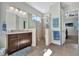 Bathroom showcases a spacious walk-in shower with a glass enclosure and designer tile, along with a modern vanity at 12809 Rainwashed Loop, Parrish, FL 34219