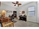 Bedroom featuring hardwood floors, piano, desk, and a leaf-bladed ceiling fan at 12809 Rainwashed Loop, Parrish, FL 34219