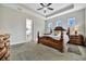 Inviting bedroom showcasing a decorative ceiling fan, natural lighting, and ornate wooden furniture at 12809 Rainwashed Loop, Parrish, FL 34219