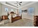 Bright main bedroom with detailed ceiling fan, recessed lighting, and charming decor at 12809 Rainwashed Loop, Parrish, FL 34219