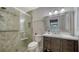 This bathroom features a glass shower, vanity with sink and medicine cabinet at 1310 Grand Blvd # 202, Sarasota, FL 34232