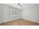 This bedroom features wood-look tile, a ceiling fan and a large window for natural light at 1310 Grand Blvd # 202, Sarasota, FL 34232