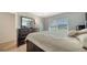 This bedroom features wood-look tile, a ceiling fan and a large window for natural light at 1310 Grand Blvd # 202, Sarasota, FL 34232